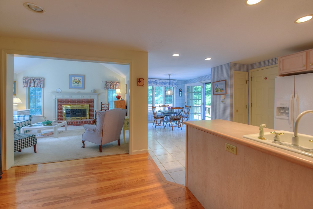 65 Tupelo Road Barnstable, MA 02635 - Photo 14 of 27 a living room with furniture wooden floor and a fireplace