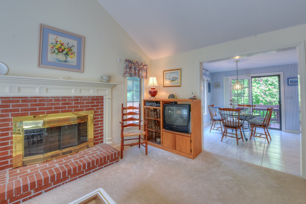 65 Tupelo Road Barnstable, MA 02635 - Photo 16 of 27 a living room with furniture a fireplace and a floor to ceiling window