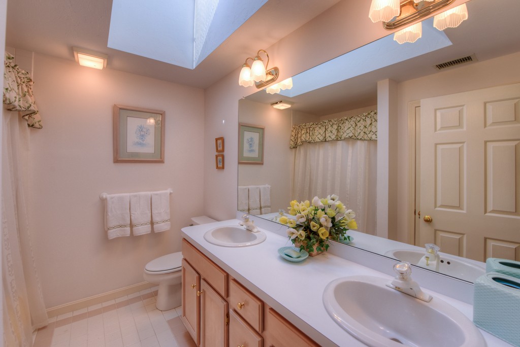 65 Tupelo Road Barnstable, MA 02635 - Photo 21 of 27 a bathroom with a granite countertop sink a toilet and a mirror