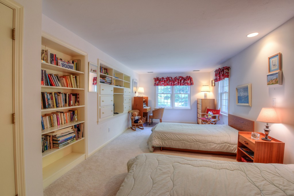 65 Tupelo Road Barnstable, MA 02635 - Photo 22 of 27 a bedroom with furniture and a book shelf