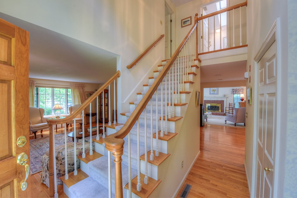 65 Tupelo Road Barnstable, MA 02635 - Photo 6 of 27 a view of staircase with lots of frames on wall and a window