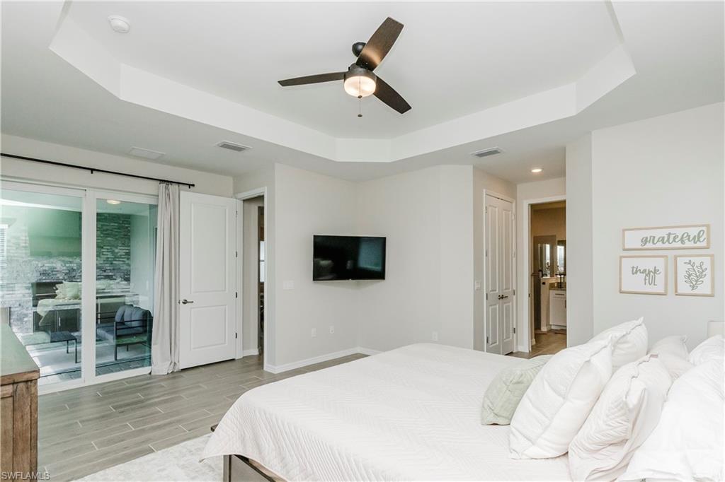 15862 Sugar Hl Drive Babcock Ranch, FL 33982 - Photo 13 of 50 a bedroom with a bed and a flat screen tv