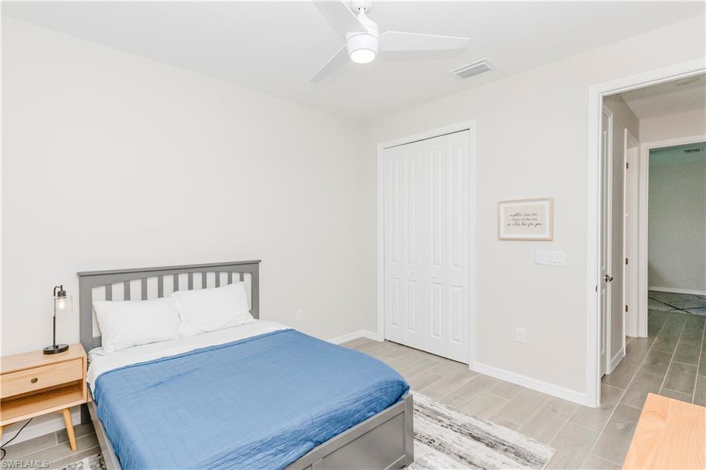 15862 Sugar Hl Drive Babcock Ranch, FL 33982 - Photo 20 of 50 a bedroom with a bed and wooden floor