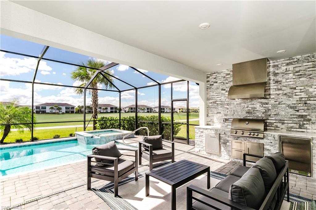 15862 Sugar Hl Drive Babcock Ranch, FL 33982 - Photo 27 of 50 a living room with fireplace furniture and a floor to ceiling window