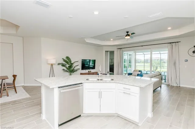 a kitchen with a sink and white cabinets