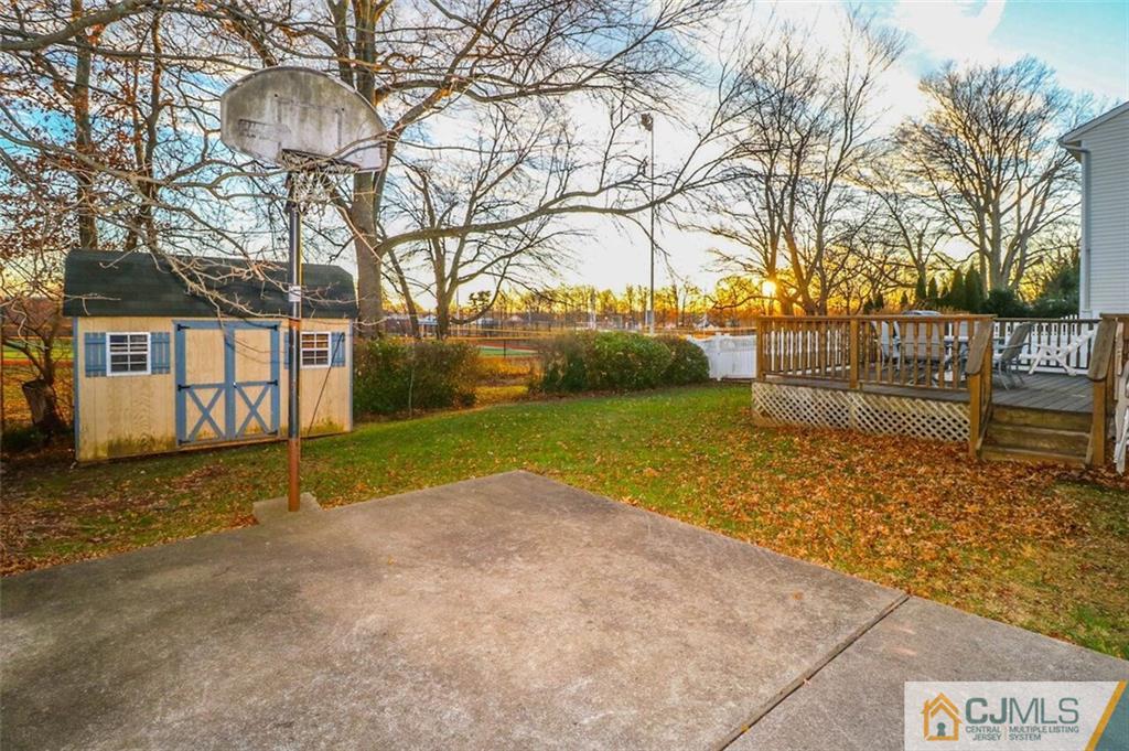 11 Westminster Road Colonia, NJ 07067 - Photo 23 of 24 a view of a yard with a house and trees in the background