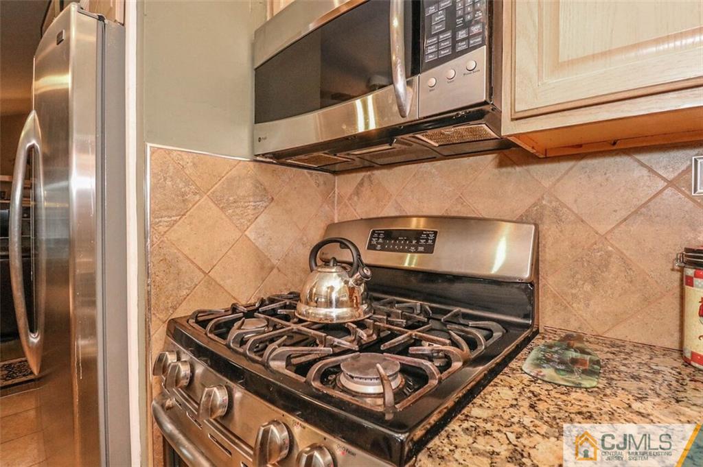 11 Westminster Road Colonia, NJ 07067 - Photo 9 of 24 a kitchen with a stove and a microwave