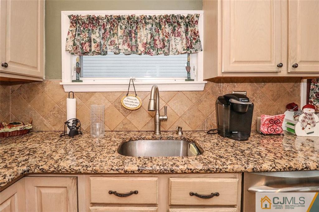 11 Westminster Road Colonia, NJ 07067 - Photo 10 of 24 a kitchen with sink a stove and cabinets