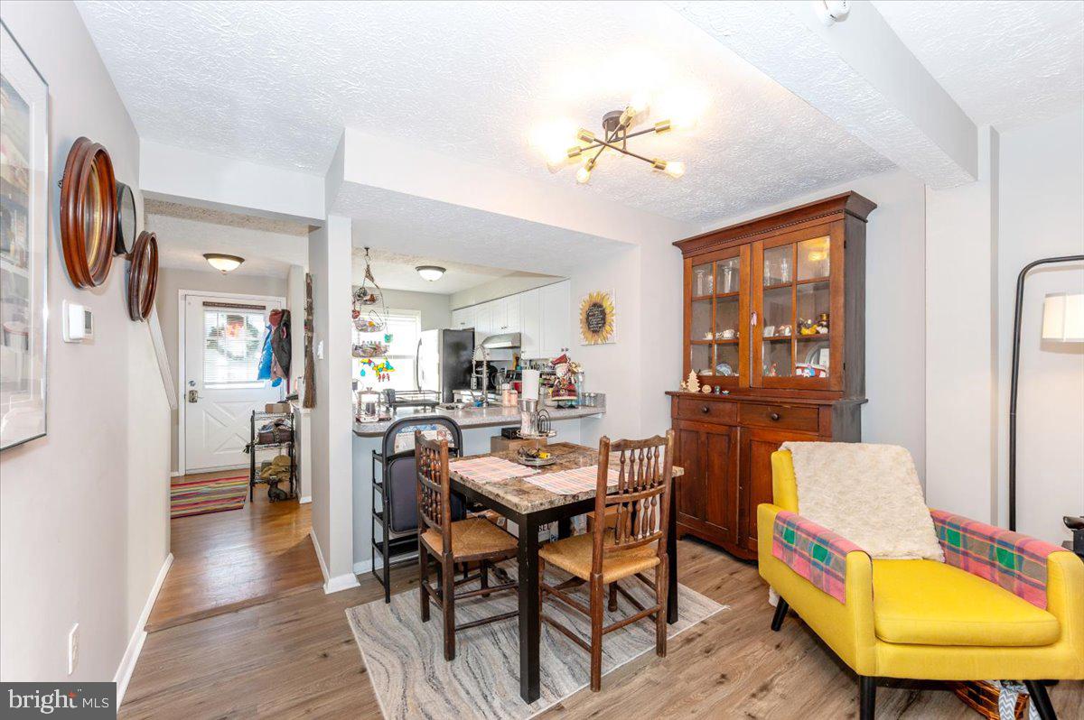 6813 Farmbrook Court Frederick, MD 21703 - Photo 11 of 40 a view of a dining room with furniture and wooden floor