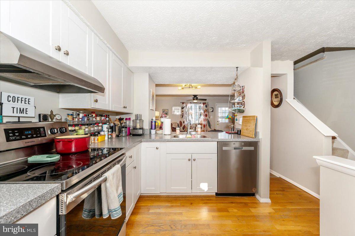 6813 Farmbrook Court Frederick, MD 21703 - Photo 18 of 40 a kitchen with stainless steel appliances granite countertop a sink and cabinets