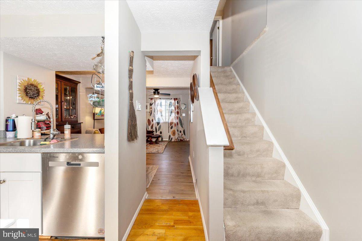 6813 Farmbrook Court Frederick, MD 21703 - Photo 19 of 40 a hallway with white cabinets and couches