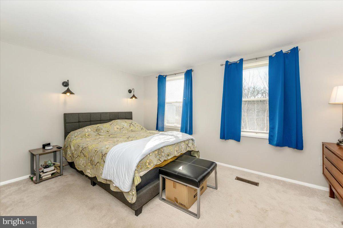 6813 Farmbrook Court Frederick, MD 21703 - Photo 22 of 40 a bedroom with a bed and a window