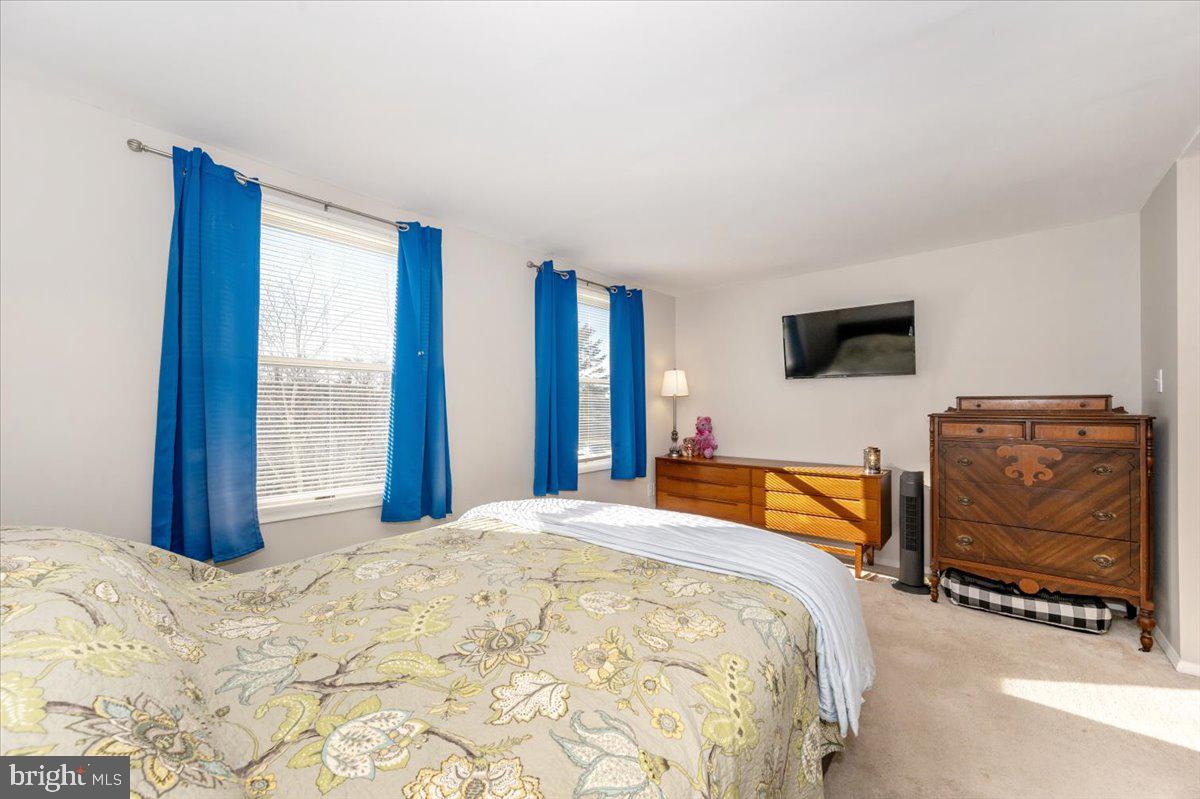 6813 Farmbrook Court Frederick, MD 21703 - Photo 24 of 40 a bedroom with a bed and dresser
