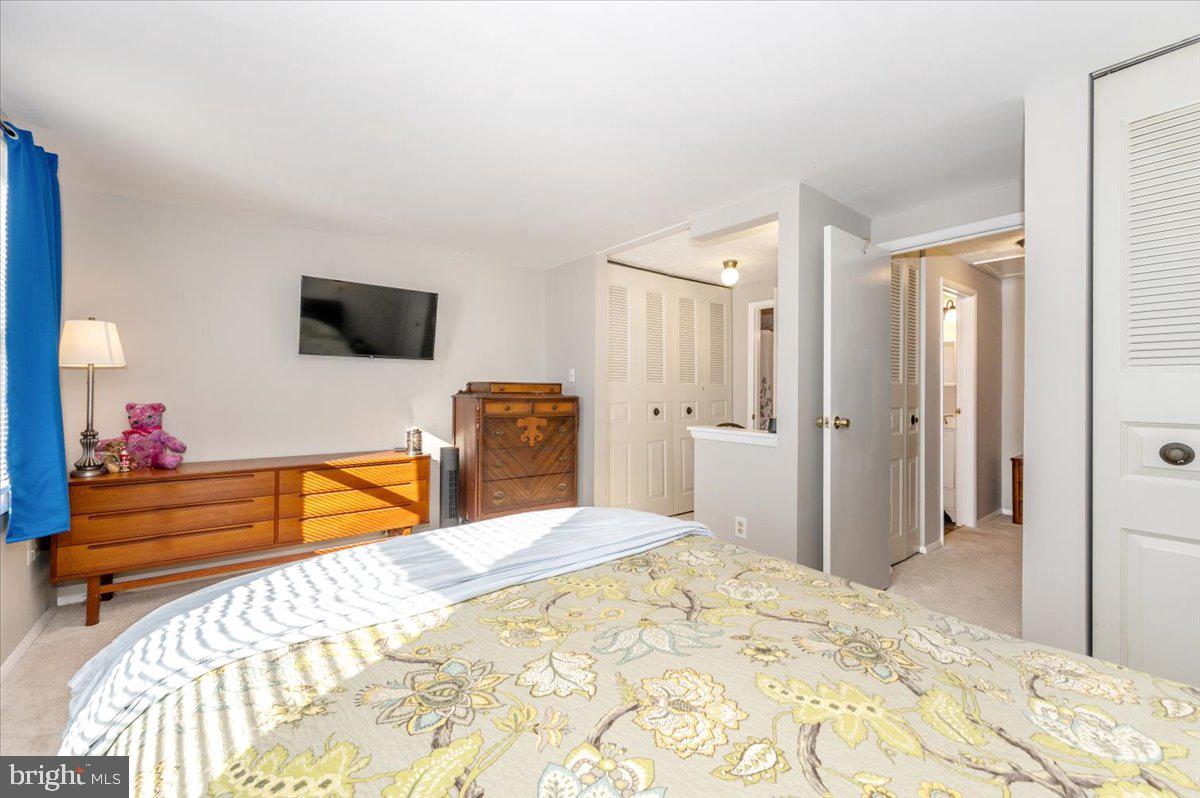 6813 Farmbrook Court Frederick, MD 21703 - Photo 25 of 40 a bedroom with a bed and a flat screen tv
