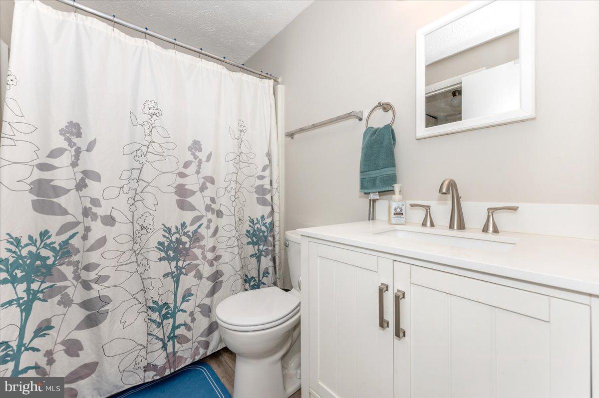 6813 Farmbrook Court Frederick, MD 21703 - Photo 28 of 40 a bathroom with a toilet sink and mirror