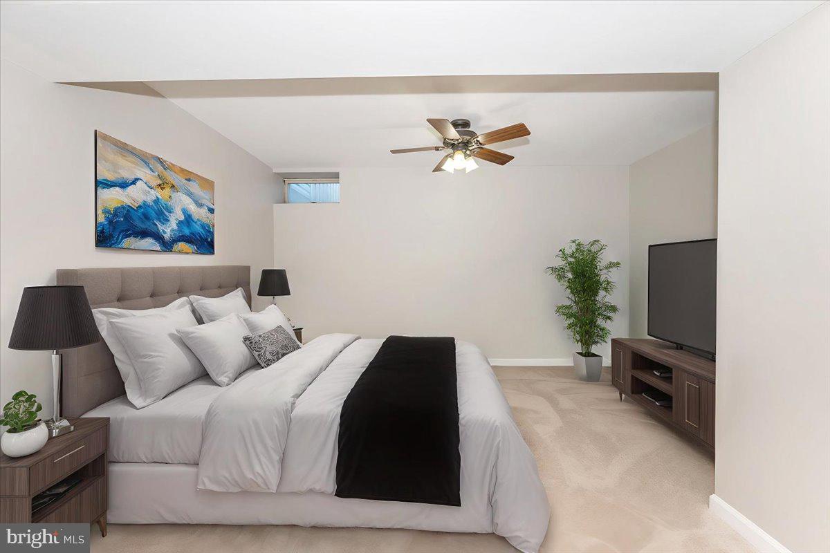 6813 Farmbrook Court Frederick, MD 21703 - Photo 29 of 40 a bedroom with a bed a wall painting and a potted plant