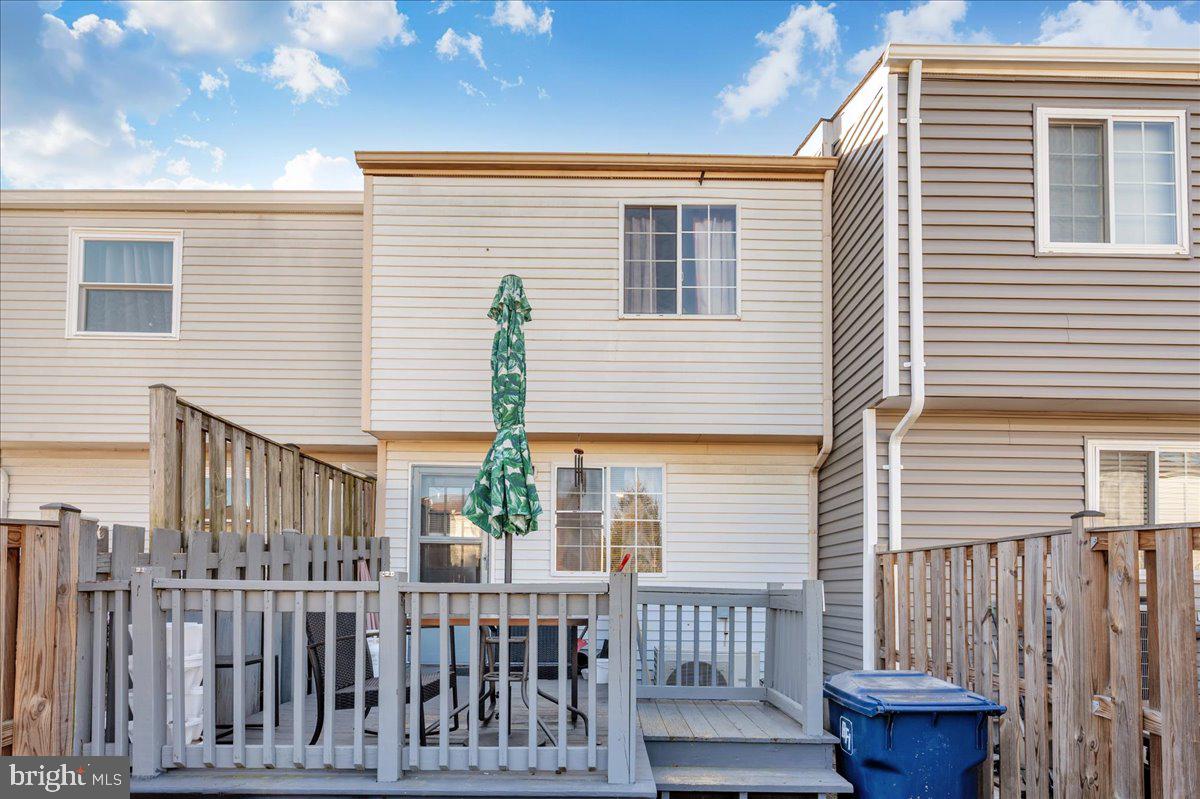 6813 Farmbrook Court Frederick, MD 21703 - Photo 33 of 40 a front view of a house with porch and wooden fence