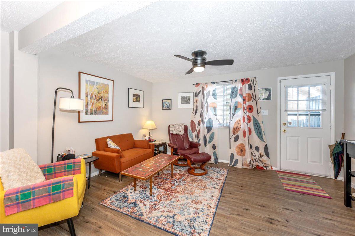 6813 Farmbrook Court Frederick, MD 21703 - Photo 5 of 40 a living room with furniture and a flat screen tv