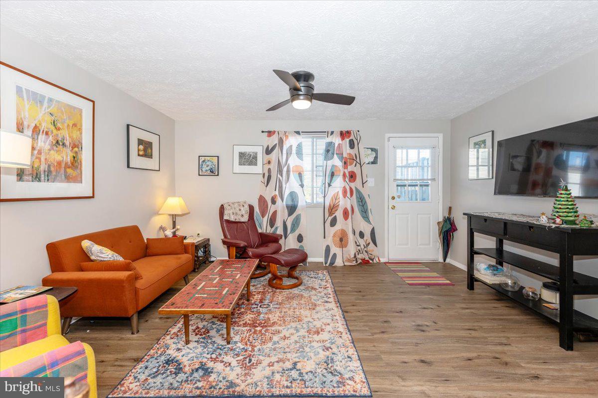 6813 Farmbrook Court Frederick, MD 21703 - Photo 6 of 40 a living room with furniture and a flat screen tv