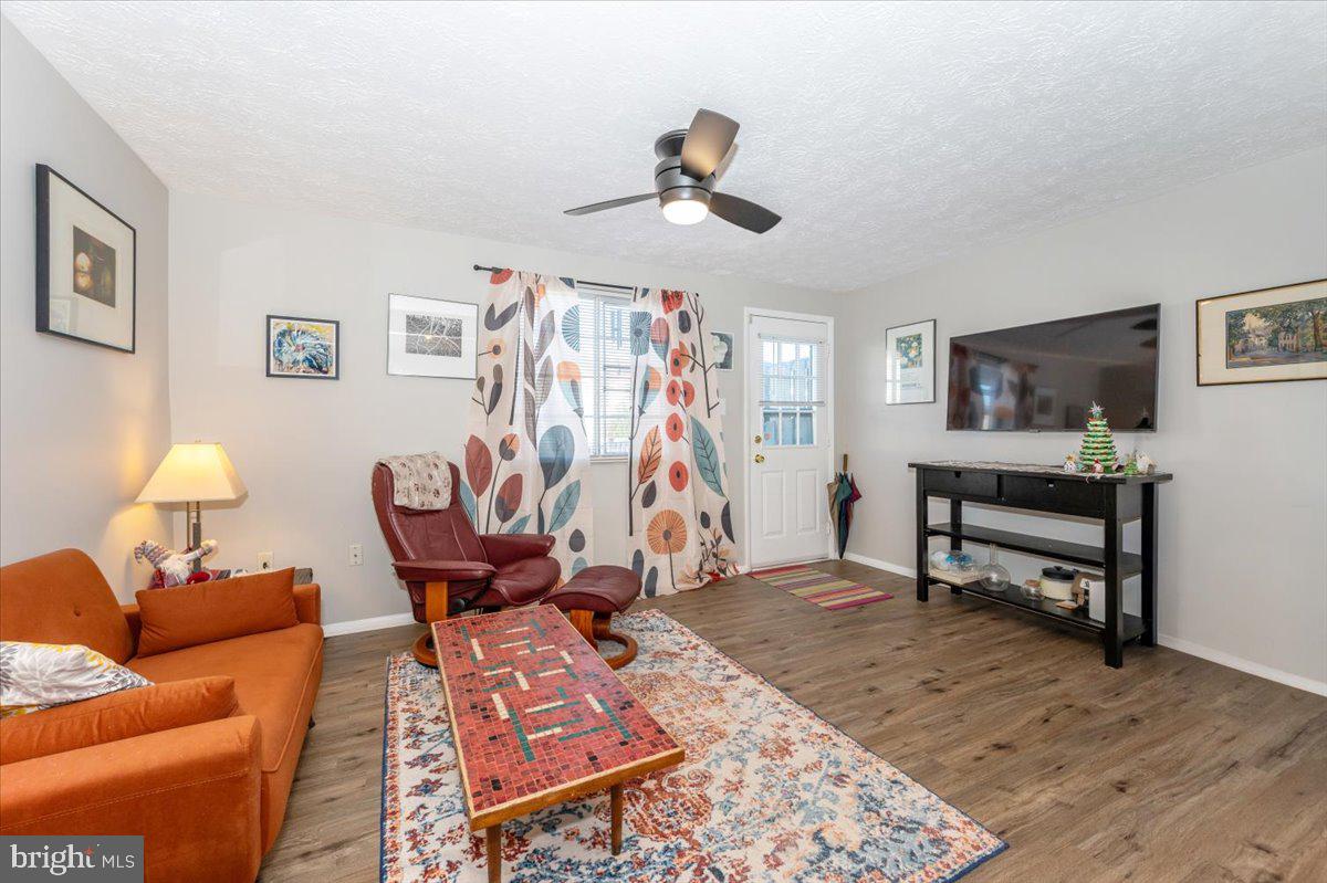 6813 Farmbrook Court Frederick, MD 21703 - Photo 7 of 40 a living room with furniture and a wooden floor