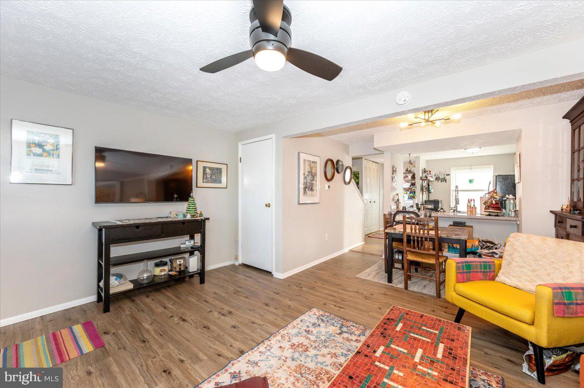 6813 Farmbrook Court Frederick, MD 21703 - Photo 8 of 40 a living room with furniture and a flat screen tv