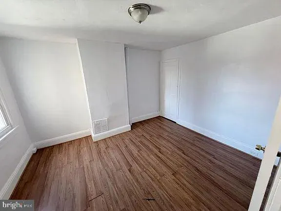 a view of wooden floor and staircase in a room