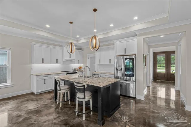 a dining hall with stainless steel appliances kitchen island granite countertop a stove a sink a dining table and chairs with wooden floor