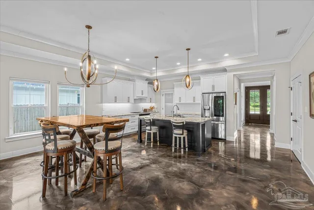 a large kitchen with a dining table and chairs