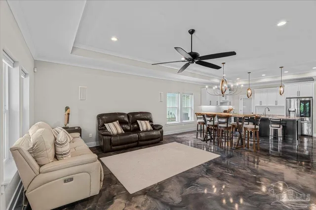 a living room with furniture a ceiling fan and a rug
