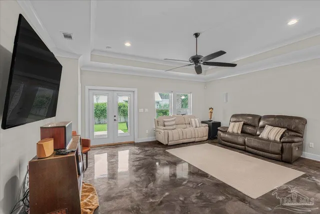 a living room with furniture a flat screen tv and a large window