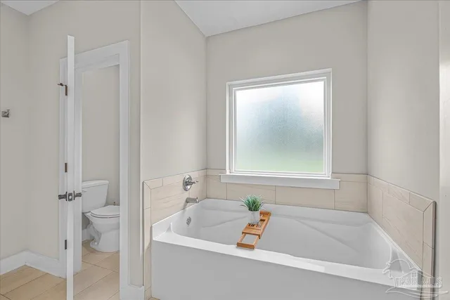 a white bath tub sitting next to a white toilet