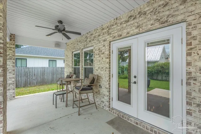 a view of a porch with chairs and backyard