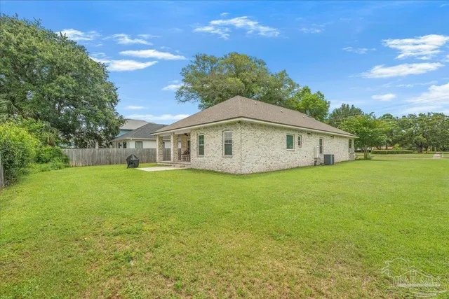 a view of a house with a backyard