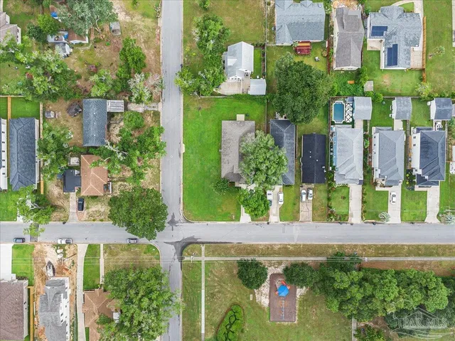 aerial view of a house with a yard and potted plants