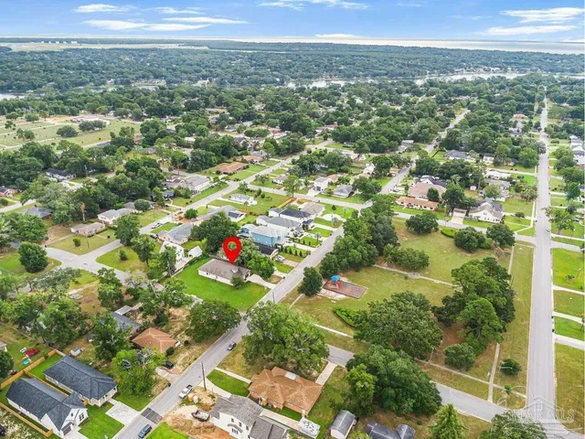 an aerial view of residential houses with outdoor space and street view