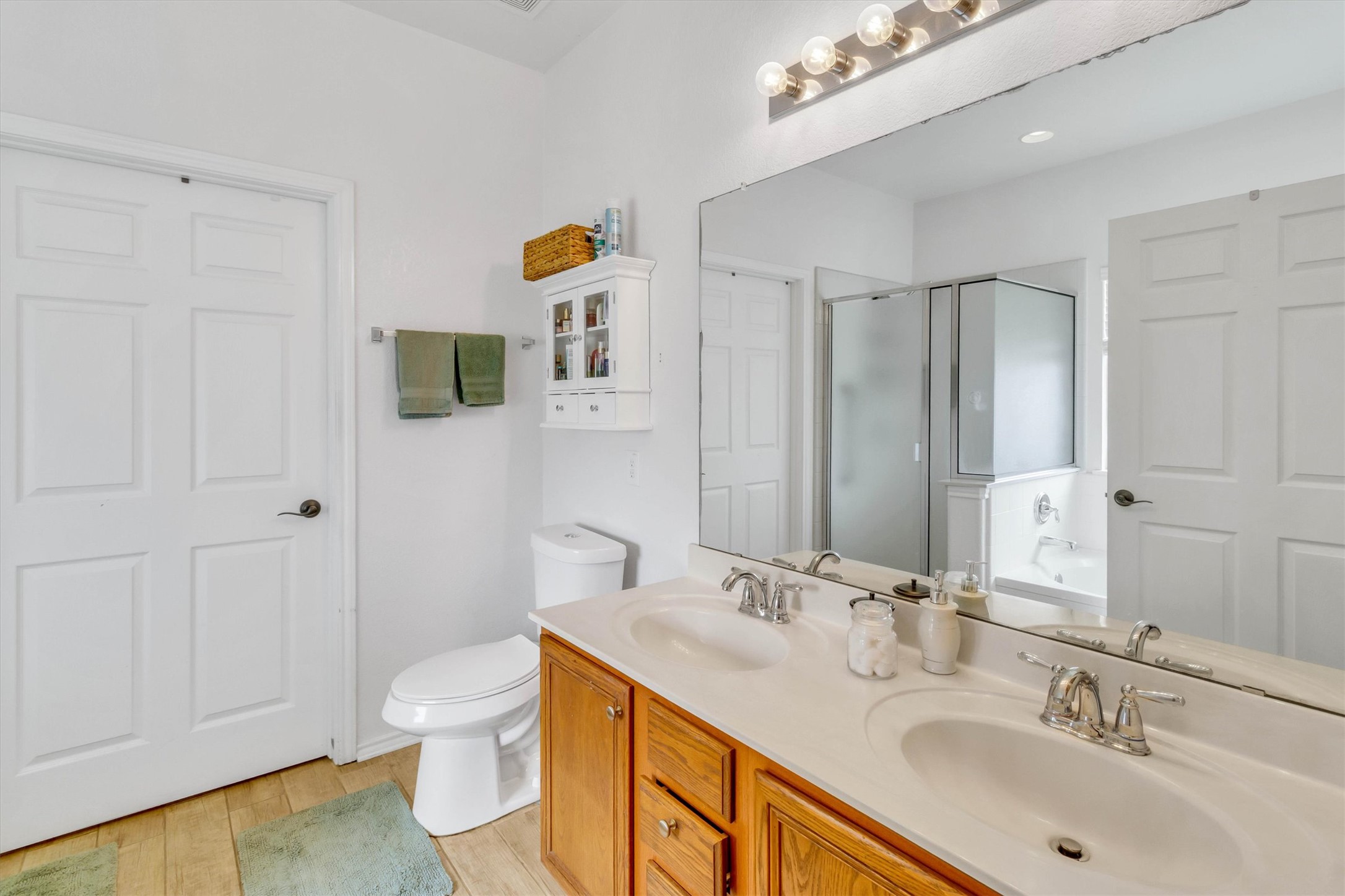 460 Waterleaf Boulevard Kyle, TX 78640 - Photo 15 of 30 Double vanities with ample counter space offer a bright and functional bathroom layout.