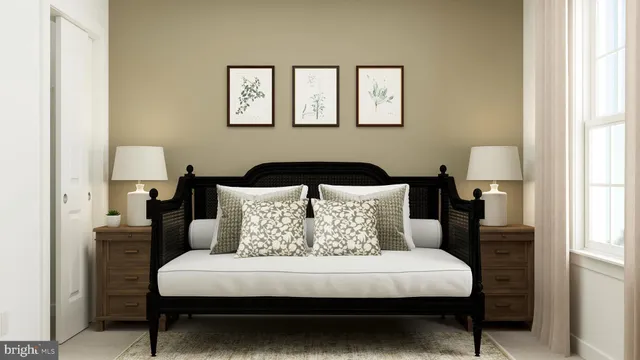 a bed sitting in a bedroom next to a window with a lamp