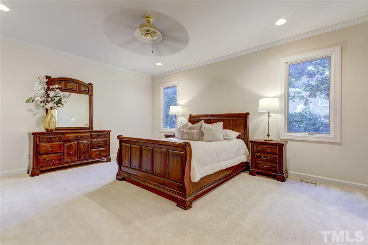 19 Covington Lane Durham, NC 27712 - Photo 14 of 30 a bedroom with a bed and a chandelier