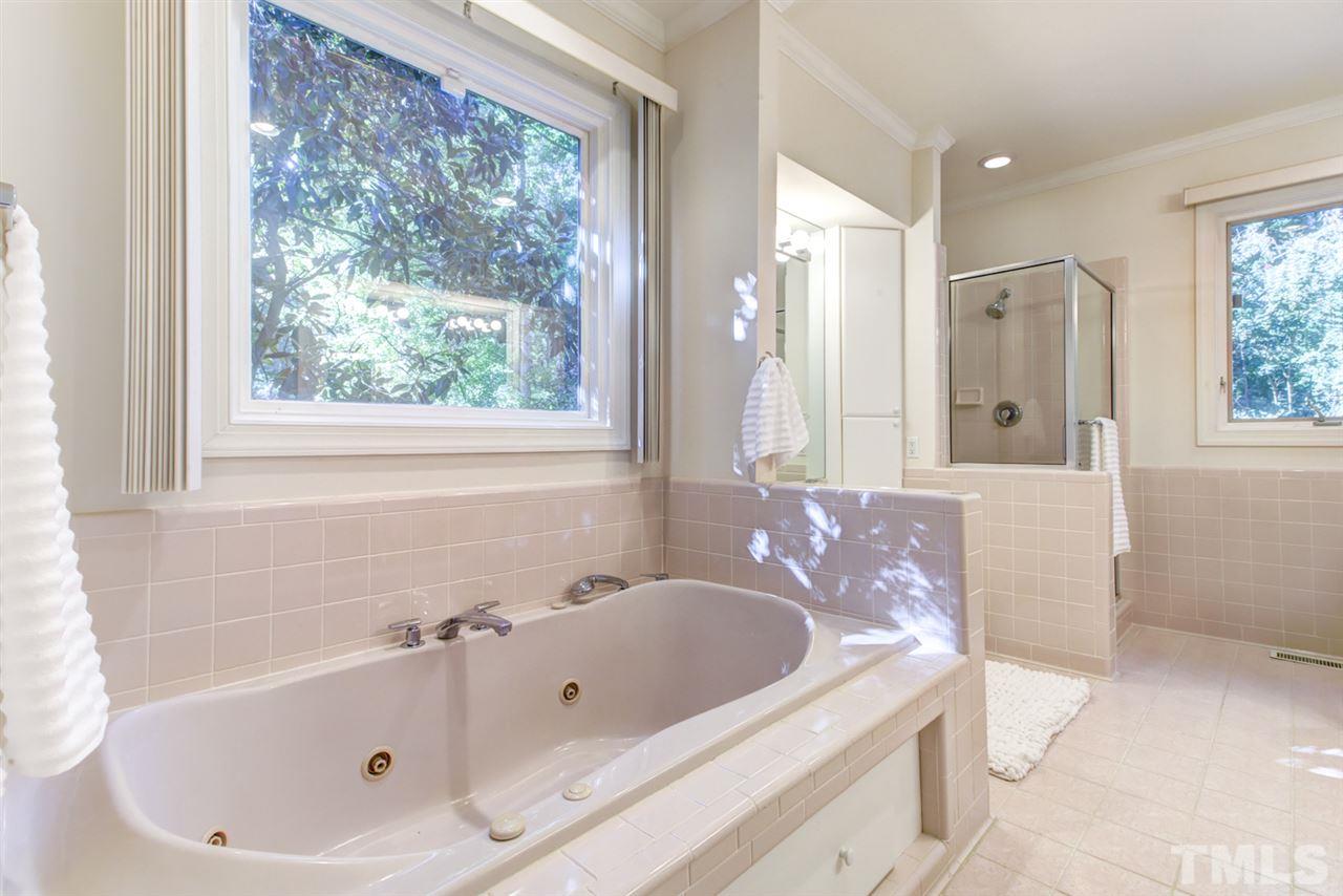19 Covington Lane Durham, NC 27712 - Photo 16 of 30 a bathroom with a tub a sink and a window
