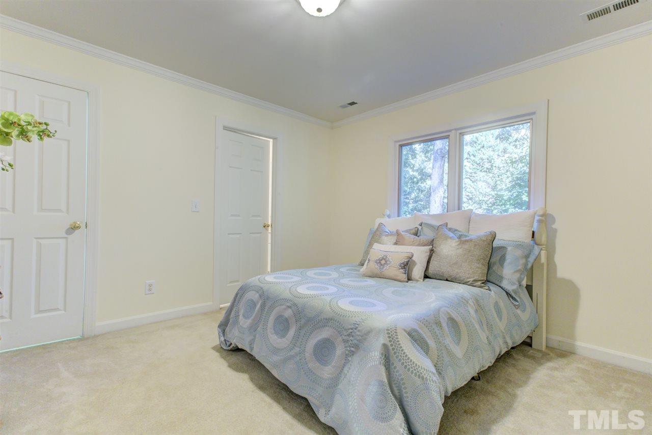 19 Covington Lane Durham, NC 27712 - Photo 21 of 30 a bedroom with a bed and a window