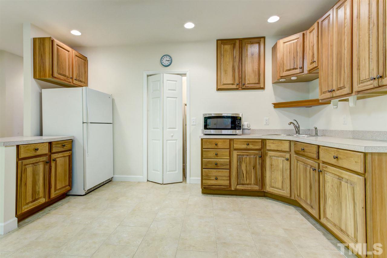 19 Covington Lane Durham, NC 27712 - Photo 23 of 30 a kitchen with stainless steel appliances granite countertop a stove a sink and a refrigerator