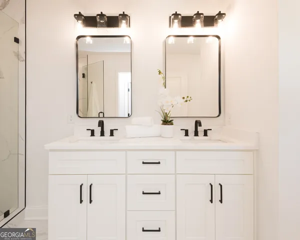 a bathroom with a shower sink and mirror