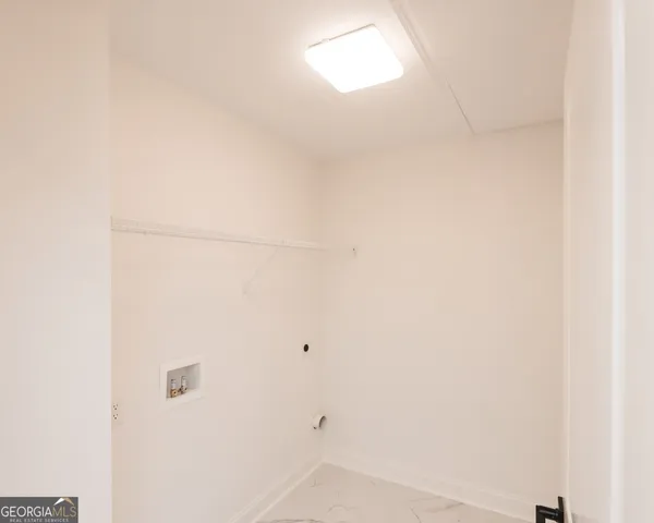 a bedroom with a bed and painting on the wall