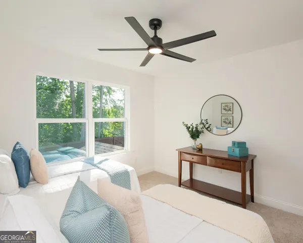 a bedroom with a large bed and a window