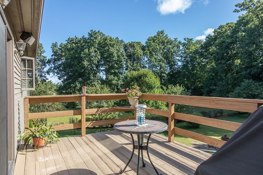 122 Bacon Road Ware, MA 01082 - Photo 10 of 29 a balcony with wooden floor and outdoor seating