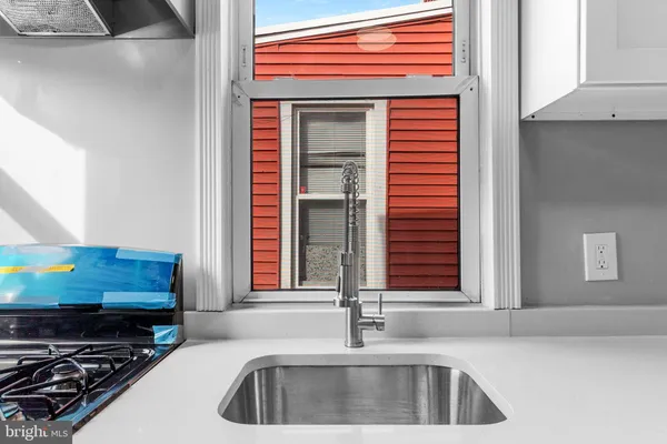 a kitchen with a sink and a stove top oven