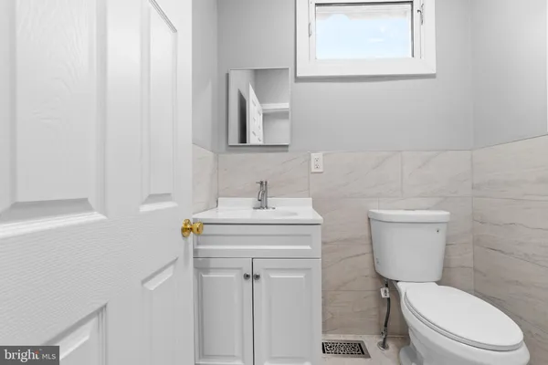 a white toilet sitting next to a bathroom sink