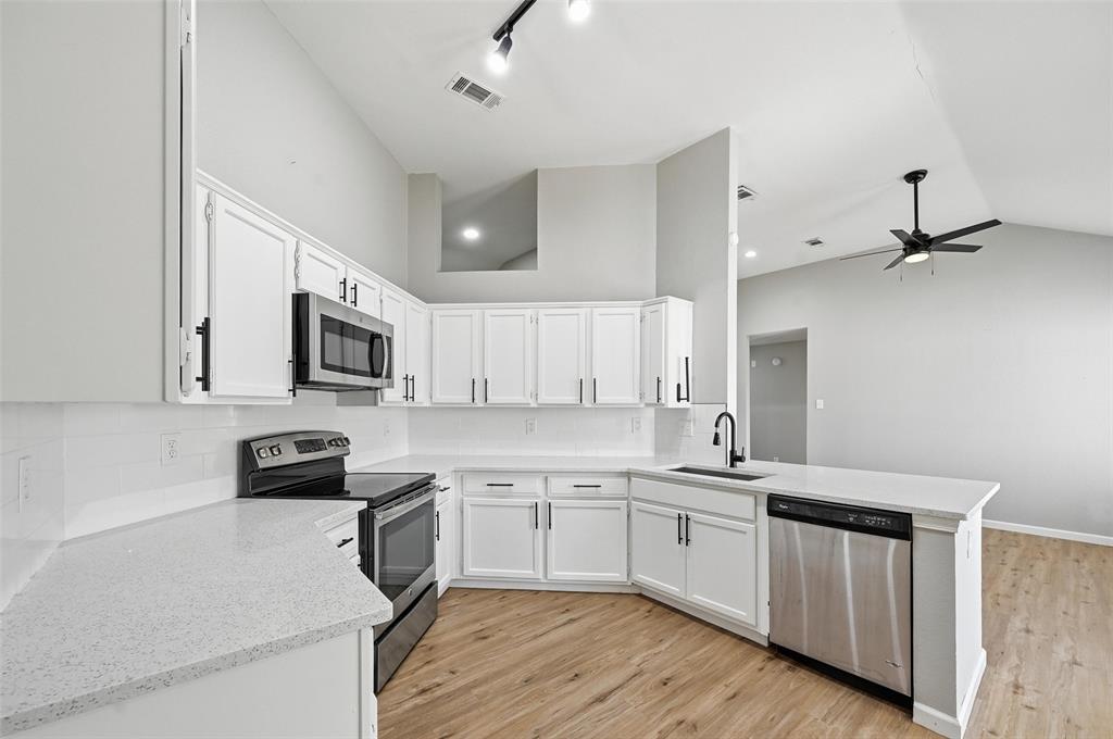 210 South Malone Road Allen, TX 75002 - Photo 11 of 36 a kitchen with white cabinets stainless steel appliances and sink