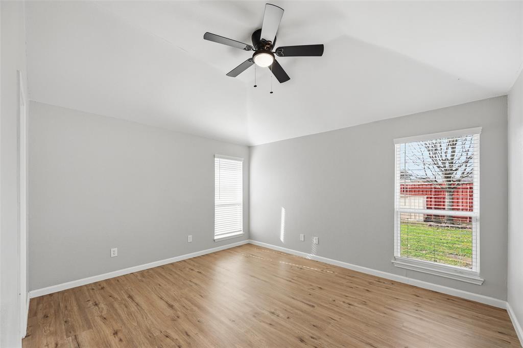 210 South Malone Road Allen, TX 75002 - Photo 16 of 36 an empty room with wooden floor fan and windows