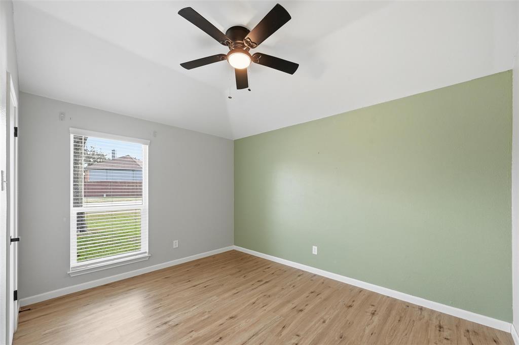 210 South Malone Road Allen, TX 75002 - Photo 19 of 36 an empty room with a window and a fan